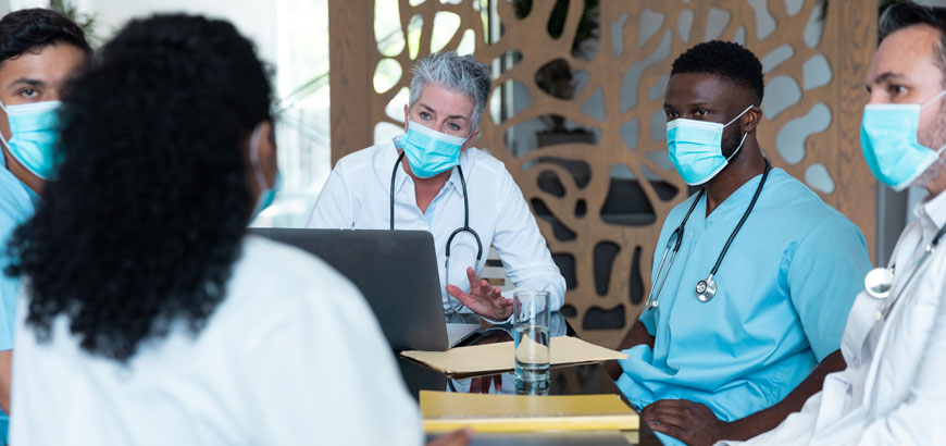 Doctors at a table having a discussion.<br>  