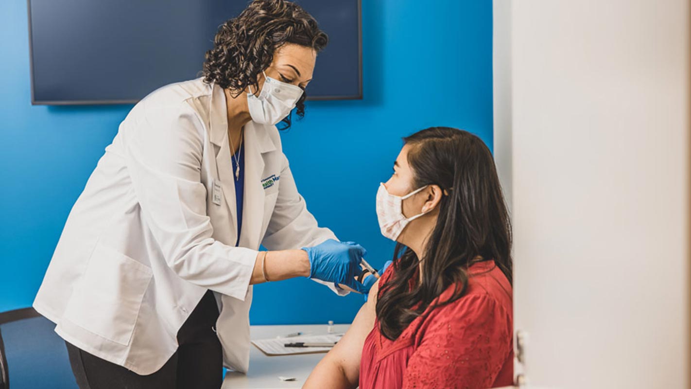 A doctor giving a patient an injection