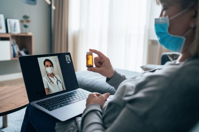 A  patient using her cell phone to video chat with a doctor